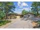 Charming home featuring a two-car garage and ample parking space with mature trees at 5073 N Lariat Dr, Castle Rock, CO 80108