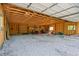 Spacious open garage interior with gravel flooring and exposed wood beams at 5073 N Lariat Dr, Castle Rock, CO 80108