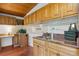 Kitchen area boasts wooden cabinets and trim, along with a granite countertop and tile backsplash at 5073 N Lariat Dr, Castle Rock, CO 80108
