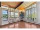 Sun-filled room with hardwood floors, large windows, and access to the balcony at 5073 N Lariat Dr, Castle Rock, CO 80108