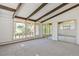 Bright and airy living room with exposed beam ceilings, large windows, and mirrored closet doors at 5073 N Lariat Dr, Castle Rock, CO 80108