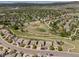An aerial view of a neighborhood with green spaces and nearby roads at 4194 Beautiful Cir, Castle Rock, CO 80109