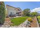 This lovely backyard offers a serene retreat with outdoor seating and manicured landscaping and a view of the house at 4194 Beautiful Cir, Castle Rock, CO 80109