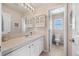 This bathroom features a well lit vanity with plentiful storage, and a water closet, providing convenience and privacy at 4194 Beautiful Cir, Castle Rock, CO 80109