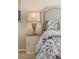 This bedroom features a decorative lamp on a round bedside table next to the luxurious upholstered headboard at 4194 Beautiful Cir, Castle Rock, CO 80109