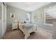 Cozy bedroom with soft, light green walls features a twin bed, closet, and bright, natural light at 4194 Beautiful Cir, Castle Rock, CO 80109