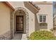 Charming front entrance with a stone archway and decorative window box under the window at 4194 Beautiful Cir, Castle Rock, CO 80109