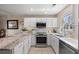 Bright kitchen features stainless steel appliances, white cabinets, tiled backsplash, and granite countertops at 4194 Beautiful Cir, Castle Rock, CO 80109