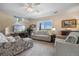 Comfortable living room with large windows, neutral decor, hardwood floors and a ceiling fan at 4194 Beautiful Cir, Castle Rock, CO 80109