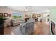 Open-concept living area with hardwood floors, neutral furniture, and a view into the dining area at 4194 Beautiful Cir, Castle Rock, CO 80109