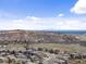 Community view with houses nestled against a hillside and distant skyline at 16052 Deer Ridge Dr # B, Morrison, CO 80465