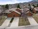 Stunning aerial view of a beautiful two-story home with a tile roof and an attached two-car garage at 16052 Deer Ridge Dr # B, Morrison, CO 80465