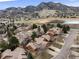 Stunning aerial view of the community with mountain backdrop and scenic lake at 16052 Deer Ridge Dr # B, Morrison, CO 80465