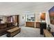 Basement with full-sized cabinets, bar refrigerator, adjacent to a lounge area with a comfortable sofa at 16052 Deer Ridge Dr # B, Morrison, CO 80465
