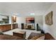 Basement with wet bar, full-sized cabinets, bar refrigerator, and a big-screen television at 16052 Deer Ridge Dr # B, Morrison, CO 80465