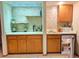 Basement bar with shelving, refrigerator, sink, and wood cabinets at 16052 Deer Ridge Dr # B, Morrison, CO 80465