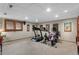 Home workout area with ceiling lights, wood trim, framed pictures and workout equipment at 16052 Deer Ridge Dr # B, Morrison, CO 80465