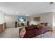 Basement living room with carpet, television, and tan leather sofa in a finished space at 16052 Deer Ridge Dr # B, Morrison, CO 80465