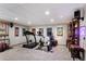 Spacious basement gym with treadmill, stationary bikes, custom shelving and recessed lighting at 16052 Deer Ridge Dr # B, Morrison, CO 80465