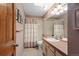 Bathroom featuring a single sink, shower, toilet, and tiled floors at 16052 Deer Ridge Dr # B, Morrison, CO 80465