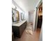 A full bathroom featuring double sinks, gray cabinetry, and a walk-in closet at 16052 Deer Ridge Dr # B, Morrison, CO 80465