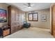 Bright bedroom with a built-in wardrobe, a window, and a comfortable leather armchair at 16052 Deer Ridge Dr # B, Morrison, CO 80465
