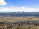 Panoramic view of the city skyline from a hilltop community, with distant mountains in the background at 16052 Deer Ridge Dr # B, Morrison, CO 80465