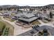 Aerial view of the expansive clubhouse, featuring a golf course, outdoor seating, and manicured landscaping at 16052 Deer Ridge Dr # B, Morrison, CO 80465