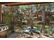 Beautiful deck featuring seating for four, complete with a grill, and surrounding foliage at 16052 Deer Ridge Dr # B, Morrison, CO 80465