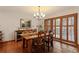 Charming dining room with hardwood floors, wood table, and natural light from door and window at 16052 Deer Ridge Dr # B, Morrison, CO 80465