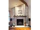 Close-up of the brick fireplace with decorative mantle and decor at 16052 Deer Ridge Dr # B, Morrison, CO 80465