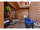 Covered front porch with cozy seating area, outdoor fire pit, and tasteful decorations at 16052 Deer Ridge Dr # B, Morrison, CO 80465