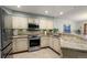 Modern kitchen with granite countertops, stainless steel appliances, and plenty of cabinet space at 16052 Deer Ridge Dr # B, Morrison, CO 80465