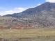 Expansive landscape featuring a mountain range and low-lying buildings at 16052 Deer Ridge Dr # B, Morrison, CO 80465