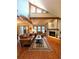 Cozy living room with hardwood floors, brick fireplace, and lots of natural light from the windows above at 16052 Deer Ridge Dr # B, Morrison, CO 80465