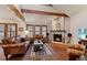 Bright living room with brick fireplace, wood floors, beamed ceilings and lots of light at 16052 Deer Ridge Dr # B, Morrison, CO 80465