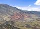 Expansive mountain landscape showcasing unique red rock formations, lush greenery, and distant structures at 16052 Deer Ridge Dr # B, Morrison, CO 80465