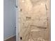 Detailed view of a marble tiled shower with a built-in niche, seat, and sleek shower head at 16052 Deer Ridge Dr # B, Morrison, CO 80465