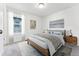 Bright bedroom with wood bed frame and large window at 4304 Ridgewalk Pt, Castle Rock, CO 80108