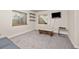 Basement with carpet, light walls, TV, bench, and shelving, offers a cozy and versatile living space at 6868 Johnson St, Arvada, CO 80004