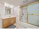 Well-maintained bathroom featuring a vanity, tub with shower, and tiled floor at 6868 Johnson St, Arvada, CO 80004