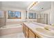 Bathroom with double sinks, tub, separate shower and natural light at 6868 Johnson St, Arvada, CO 80004