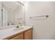 Half bathroom features a large mirror and wooden vanity at 6868 Johnson St, Arvada, CO 80004