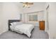 Comfortable bedroom featuring vaulted ceilings, large windows, and neutral carpet at 6868 Johnson St, Arvada, CO 80004