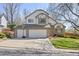 Charming two-story home with a three-car garage and basketball hoop on a sunny day at 6868 Johnson St, Arvada, CO 80004