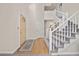 Bright foyer featuring wood floors, carpeted stairs, and high ceilings at 6868 Johnson St, Arvada, CO 80004