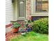 A charming front entrance is adorned with colorful flowers and greenery at 6868 Johnson St, Arvada, CO 80004