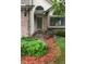Inviting front entrance with brick accents, lush landscaping, and a well-maintained lawn at 6868 Johnson St, Arvada, CO 80004