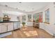 Bright kitchen with hardwood floors and stainless steel dishwasher at 6868 Johnson St, Arvada, CO 80004