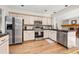 Well-lit kitchen with stainless steel appliances and light wood cabinets at 6868 Johnson St, Arvada, CO 80004